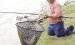 Johnny Mai, Garden City, with one of the carp he hauled in last Saturday afternoon. He landed the two large carp over the weekend, weighing in at 16.86 pounds and 15.18 pounds. (Record Photo)