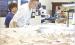 Sandi Unruh, Marienthal, takes a closer look through a microscope at an elasmosaurus fossil that’s in the preparation stage in the Western Kansas Fossil Lab in the El Quartelejo Museum. (Record Photo)