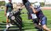 SCHS assistant coach Drew Kite encourages the linemen as they work out on the blocking sled during the opening day of practice on Monday. (Record Photo)