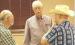 State Rep. Jim Minnix (R-Scott City) visits with two constituents during a candidate forum in Scott City last Thursday. (Record Photo)