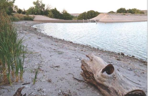 Siphon tubes at the spillway have drained about 3-1/2 feet of water so far from Lake Scott, which is evident by the amount of shoreline that’s been exposed. (Record Photo)
