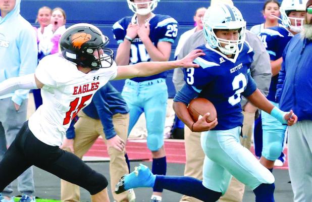 Scott City’s Pablo Solis stays beyond the reach of a Colby defender on a 56 yard punt return for a touchdown during Monday’s game on the home turf. (Record Photo)