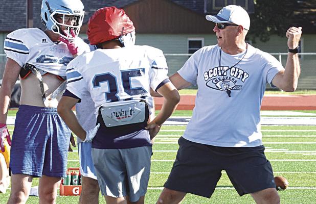 SCHS head coach Jim Turner explains how he wants offensive linemen to take the defender out of the play during Monday’s camp. (Record Photo)