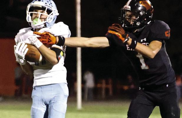 SCHS junior cornerback Adan Tarango grabs an interception during last Friday’s district win over Colby. (Record Photo)