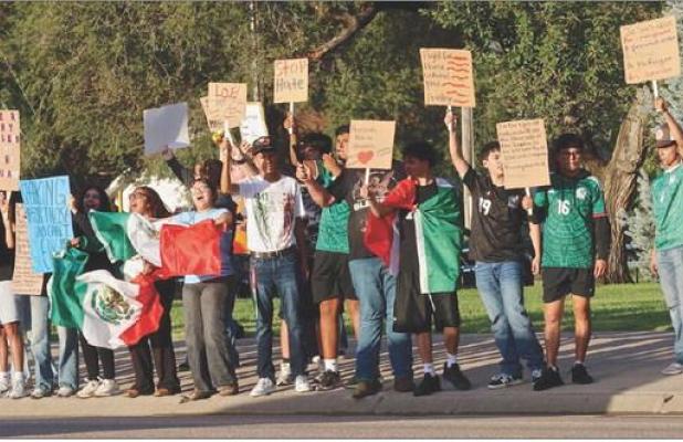 Peaceful protesters line the block at Patton Park along US83 Highway in Scott City showing their support for immigrants last Thursday evening. ( Record Photo)