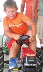 57 youngsters power up for the pedal tractor pull