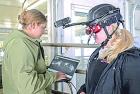 University of Wisconsin-River Falls students Megan Mosgaller (left) and Gabby Huitema use the augmented reality goggles to see through the eyes of a cow.