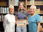 PEO members Holly Martino (left) and Linda Proehl present Avery Lewis with a $2,500 scholarship certificate.