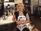 Meg Heriford, owner of Ladybird Diner in Lawrence, sits at the counter in her restaurant. She said she won’t be able to afford health insurance this year if federal subsidies expire.