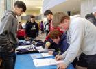 SCHS junior Kevin Peregrino (left) looks on as customers fill out order forms for sweatshirts at his Market Day booth. (Record Photo) market day