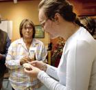 Paige Bump, an archeologist with the Kansas State Historical Society, looks over an artifact that was brought to the annual meeting. (Record Photo) Paige Bump, an archeologist with the Kansas State Historical Society, looks over an artifact that was brought to the annual meeting. (Record Photo)