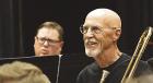 Bob Anton, a trombone player from Satanta, shares a laugh at one of Clint Raynes’ “band director jokes” during Saturday’s rehearsal for the Flatland Big Band concert. (Record Photo)
