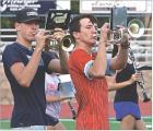 Scott Community High School marching band members Porter Wells (left) and Eli Geyer go through drills during Tuesday night’s camp session at the high school football field. The band concluded their camp on Wednesday evening with a performance for parent