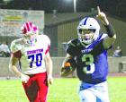 SCHS senior quarterback Dylan Metzger raises a finger in celebration as he races into the end zone with the winning touchdown in overtime against Hugoton last Friday. (Record Photo) OT thriller