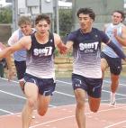 SCHS junior Martin Purma takes the baton from Adrian Garcia to begin the final leg of the 4x100m relay at the regional track meet last Thursday. (Record P hoto)