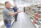 Randy Evans (foreground) and Casey Venters, director of the Lane County Community Foundation, discuss the work that’s being done to prepare the grocery store for its grand opening on June 27. (Record Photo)