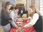 Scott Community High School senior Tara Rose (right) shows customers some bracelets that she was selling at her booth during the Entrepreneur Market Day last week. (Record Photo) market day