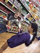 Liam O’Dea and Hailey Unruh compare prices in a grocery store as part of a recent 4-H foods workshop.