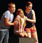 Hayden Wiechman, Blakeley Gentry (center, as their dog) and Joslyn Frolich explain how to convince their parents to let them have a dog in the musical “How to Eat Like a Child.” (Record Photo) Summer musical looks at life through the eyes of a kid