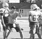 SCHS assistant coach Drew Kite works with linebackers on their technique during the first day of football camp on Monday. (Record Photo)