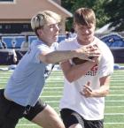 Cayden Couchman tries to strip the ball away from Peyton Bergner while working on ball security drills during the recent SCHS football clinic. (Record Photo) it’s still the details