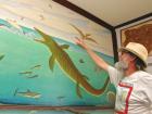Fossil hunter and artist Chuck Bonner points to his depiction of three ichthyornises soaring over the Western Interior Seaway on a mural that hangs in the Keystone Gallery. (Record Photo) Bonner’s small bird fossil is yielding big results for researchers