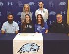 Piper Fox (second from left) recently signed a letter of intent to play basktball at Tabor College. On hand for the signing were (front row, from left) Matthew Fox, Leasha Couchman and Tabor head coach Shawn Reed. (Back row) SCHS assistant coach Tricia Go