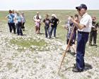 Dennie Siegrist stands by what remains of several rifle pits that overlook Battle Canyon while telling the story of the Northern Cheyenne exodus to visitors to the historic site in 2018. (Record P hoto)