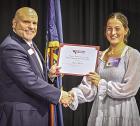 Scott Community High School junior Brinlie Stevens is recognized by Wheatland Electric Cooperative CEO Bruce Mueller as a youth tour delegate. Stevens named delegate for Wheatland Electric youth tour