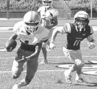 Outside linebacker Adrian Garcia returns an interception during the scrimmage against Garden City. (Record Photo)