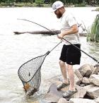 Travis Crockett, Holcomb, nets an 11.08 pound carp on Saturday during the Lake Scott carp derby. (Record Photo)