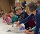 Lake Wide Awake 4-Hers unwrap gift balls during their December meeting.