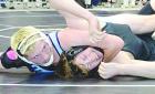 Blaze Gossman, a 165-pound senior, watches as the official awards near-fall points during his technical fall win over Zane Aikin (Frontenac). The SCHS grappler was a fourth place medalist at state. (Record Photo)