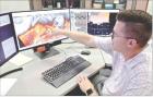 Ryan Bunker, normally based out of Norman, Okla., was on loan to the Goodland weather station for several days in June. He is monitoring weather patterns as they develop on one of his computer screens. (Record Photo)