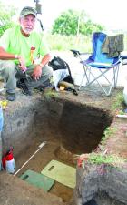Archeologist Chris Hord, Lee’s Summit, Mo., was intrigued by the darker soil in the right corner of a unit which could have been some type of storage pit. (Record Photo) Evidence should be enough to include site on National Register