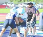 (Above) SCHS players go through tackling drills. (Right) Assistant coach Michael McEachern looks on as offensive and defensive linemen work on their technique. R( ecord Photos) (Above) SCHS players go through tackling drills. (Right) Assistant coach Michael McEachern looks on as offensive and defensive linemen work on their technique. R( ecord Photos)