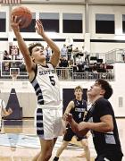 SCHS senior Drew Metzger finishes off a drive into the lane with a basket during the second half of the Beavers’ win over Cimarron in GWAC action. (Record Photo)