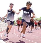 Peyton Bergner passes the baton to Adrian Garcia in the 4x100m relay. (Record Photo)