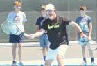 Wichita Collegiate High School tennis coach Dave Hawley gives instruction during a two-day camp in Scott City last week. (Record Photo) SC netters hit the courts for team camp, summer tournaments