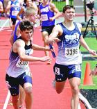 SCHS sophomore Adan Tarango takes the baton from Kasten Wren in the 4x800m relay. (Record Photo)