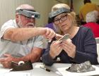 Gene Twiggs, Abilene, and Lisa McNally, Overland Park, discuss some features on pottery sherds they were piecing together in the KATP lab at the Scott County 4-H exhibit building. ( Record Photo) All artifacts, large and small, offer important clues to the past