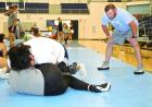 SCHS head coach Dakota Hayes observes as Lady Beavers work on turning an opponent to their back during the summer camp. (Record Photo) Article Image Alt Text