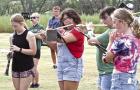 Woodwind members of the SCHS marching band practicing during their summer camp are (from left) Marly Cramer, Rebekah Walter, Camren Schmitt and Maile Depperschmidt. (Below) Director Elizabeth Janssen provides instruction on where members should be while w the ‘boys’ of fall