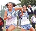 Halle Erazo (right) passes the baton to Lily Lightner in the 4x100m relay at the regional meet. The Lady Beavers finished in second place. R(ecord Photo)