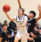 Driving into the lane for a basket during junior varsity action against Holcomb last Friday is Scott City’s Ethan Faurot. (Record Photo)