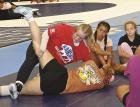 Marissa Porsch, a former high school state champion and the assistant coach at Barton County Community College, demonstrates one way of turning a wrestler to their back during last week’s camp. (Record Photo)
