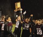 Surrounded by his teammates, WCHS senior Cordell Brown raises the championship trophy following their 54-36 win over Little River in the 8-Man-DI title game in Newton last Saturday. (Record Photo) it came down to trust