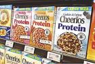 A Cheerios cereal box lineup touts its enhanced protein properties at a grocery store A Cheerios cereal box lineup touts its enhanced protein properties at a grocery store