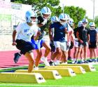 The Beavers go through conditioning drills on the opening day of practice. (Record Photo)