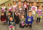 Adina Hassler surrounded by a few of the more than 60 kindergarten students at SCES who received her annual book donation. (Record Photo) Kindergartners get early start on experience of having their own book